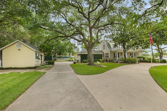 916 E James St, Baytown, TX 77520 - view of front of home with a front yard and driveway