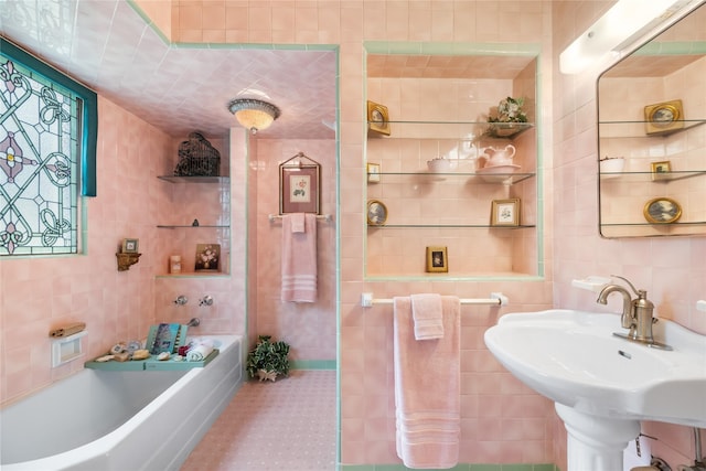 916 E James St, Baytown, TX 77520 - full bathroom with tile walls, a bath, and a sink