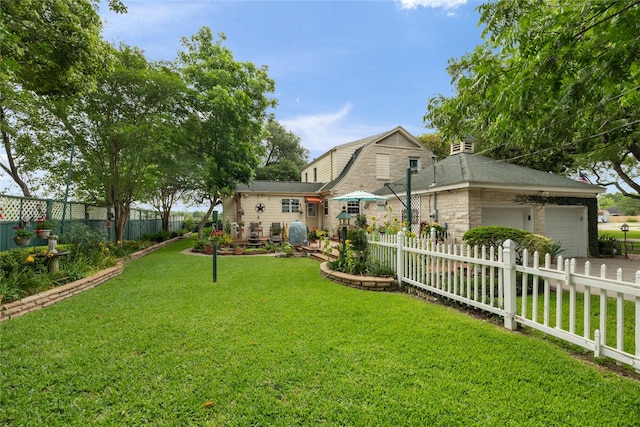 916 E James St, Baytown, TX 77520 - view of yard featuring an attached garage and driveway