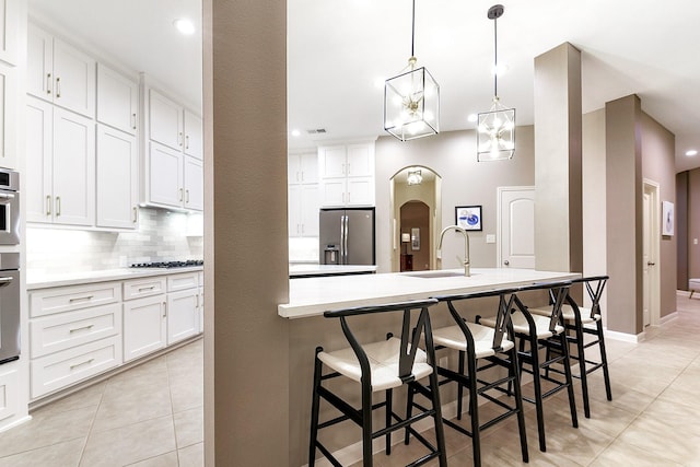 28515 Blue Holly Ln, Katy, TX 77494 - kitchen with stainless steel appliances, light tile patterned flooring, a sink, backsplash, and recessed lighting