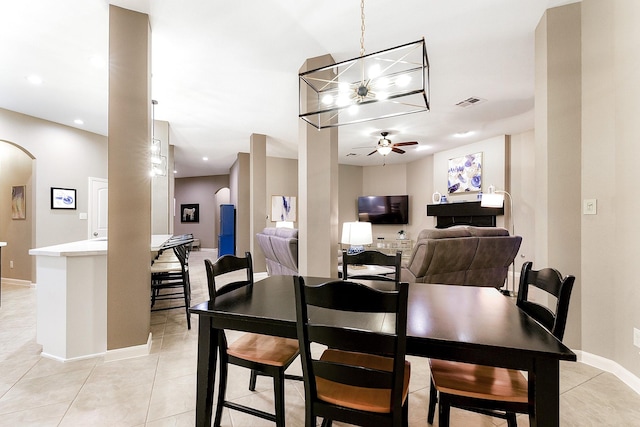 28515 Blue Holly Ln, Katy, TX 77494 - dining area featuring ceiling fan, light tile patterned flooring, a chandelier, and arched walkways