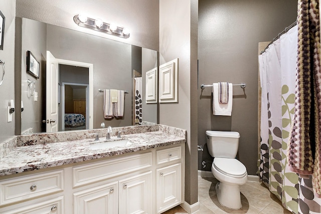28515 Blue Holly Ln, Katy, TX 77494 - full bathroom featuring toilet, vanity, ensuite bath, tile patterned floors, and baseboards
