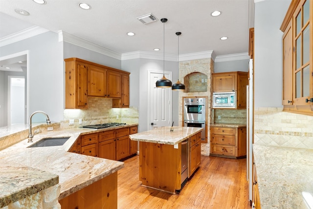2042 Darby Ln, Fresno, TX 77545 - kitchen with a sink, appliances with stainless steel finishes, light wood-style floors, light stone counters, and brown cabinetry