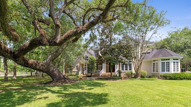 2042 Darby Ln, Fresno, TX 77545 - view of front of property featuring a front yard, stucco siding, and french doors