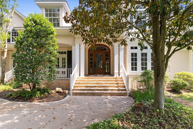 2042 Darby Ln, Fresno, TX 77545 - view of exterior entry featuring stucco siding, a porch, and french doors