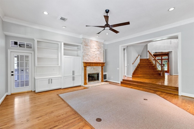2042 Darby Ln, Fresno, TX 77545 - unfurnished living room with a ceiling fan, light wood finished floors, ornamental molding, a stone fireplace, and recessed lighting
