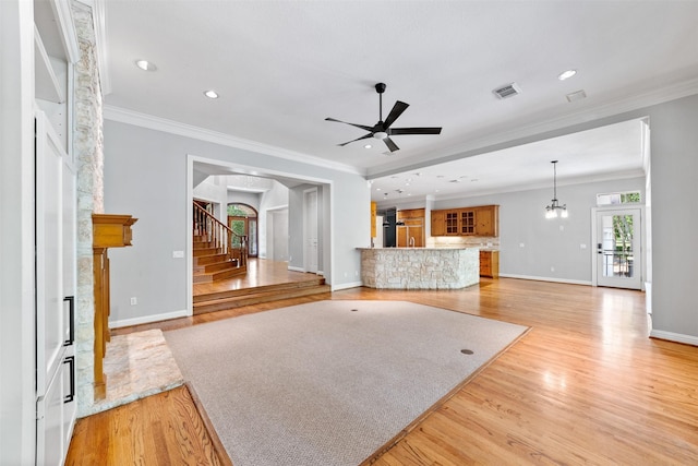 2042 Darby Ln, Fresno, TX 77545 - unfurnished living room with a fireplace, light wood-style flooring, baseboards, stairs, and ceiling fan