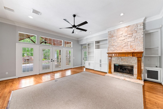 2042 Darby Ln, Fresno, TX 77545 - unfurnished living room with a ceiling fan, light wood finished floors, crown molding, a stone fireplace, and baseboards