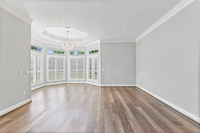 2042 Darby Ln, Fresno, TX 77545 - empty room featuring a chandelier, baseboards, wood finished floors, crown molding, and a tray ceiling