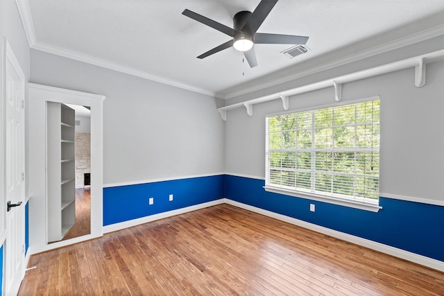 2042 Darby Ln, Fresno, TX 77545 - spare room with ceiling fan, hardwood / wood-style flooring, ornamental molding, baseboards, and a fireplace