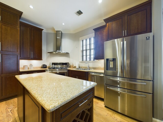 6319 Riverview Way, Houston, TX 77057 - kitchen with stainless steel appliances, wall chimney exhaust hood, a sink, crown molding, and light stone counters