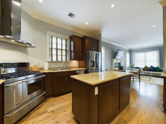 6319 Riverview Way, Houston, TX 77057 - kitchen with appliances with stainless steel finishes, wall chimney exhaust hood, a sink, plenty of natural light, and recessed lighting