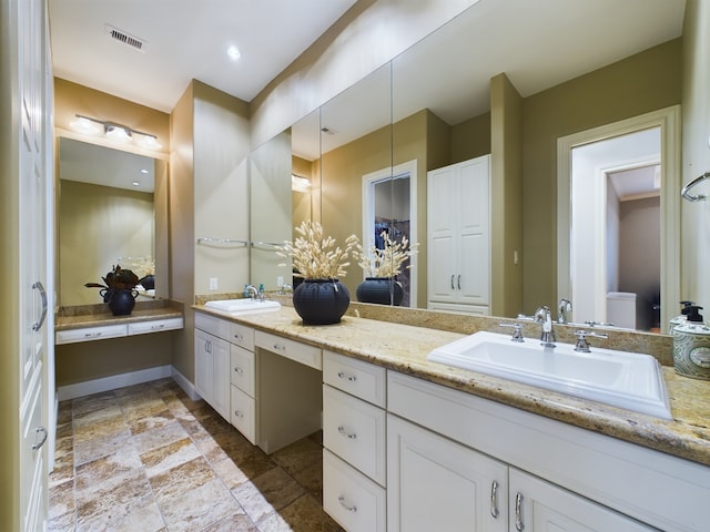 6319 Riverview Way, Houston, TX 77057 - full bath with double vanity, stone finish flooring, and toilet