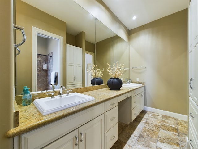 6319 Riverview Way, Houston, TX 77057 - full bath with double vanity, stone tile floors, and baseboards