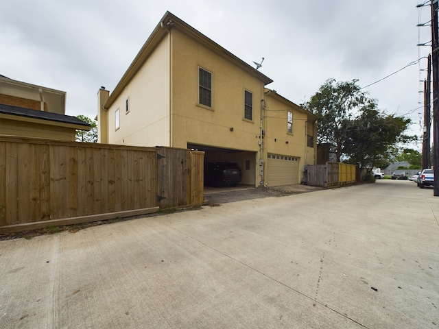 6319 Riverview Way, Houston, TX 77057 - view of home's exterior with a garage, stucco siding, and concrete driveway