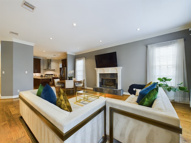 6319 Riverview Way, Houston, TX 77057 - living room with ornamental molding, recessed lighting, a tile fireplace, baseboards, and light wood-style flooring