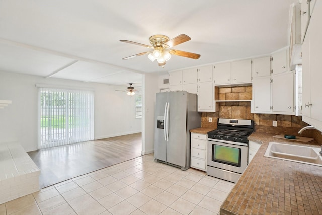 2112 Leyte Dr, Tool, TX 75143 - kitchen featuring appliances with stainless steel finishes, a sink, a ceiling fan, tasteful backsplash, and open floor plan