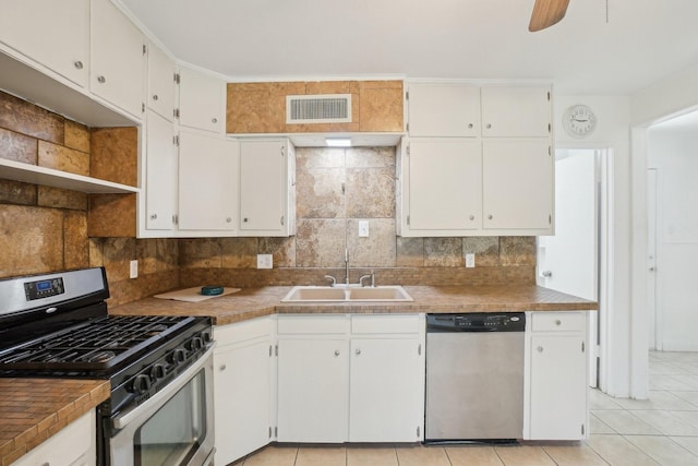2112 Leyte Dr, Tool, TX 75143 - kitchen with stainless steel appliances, a sink, open shelves, decorative backsplash, and white cabinetry
