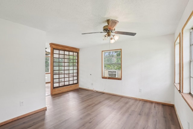 2112 Leyte Dr, Tool, TX 75143 - unfurnished room featuring wood finished floors, ceiling fan, baseboards, a textured ceiling, and cooling unit