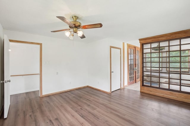 2112 Leyte Dr, Tool, TX 75143 - spare room featuring wood finished floors, french doors, baseboards, and a ceiling fan