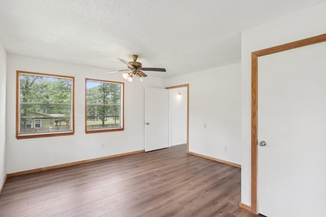 2112 Leyte Dr, Tool, TX 75143 - unfurnished room featuring ceiling fan, wood finished floors, baseboards, and a textured ceiling