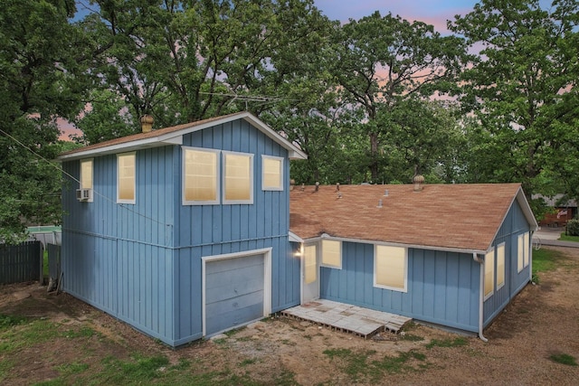 2112 Leyte Dr, Tool, TX 75143 - view of front of property with view of wooded area, a shingled roof, a chimney, a garage, and board and batten siding