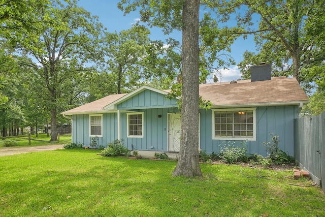 2112 Leyte Dr, Tool, TX 75143 - view of front of house with board and batten siding, a chimney, and roof with shingles