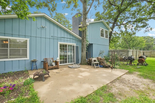 2112 Leyte Dr, Tool, TX 75143 - rear view of property with a fire pit, board and batten siding, a patio area, and a chimney