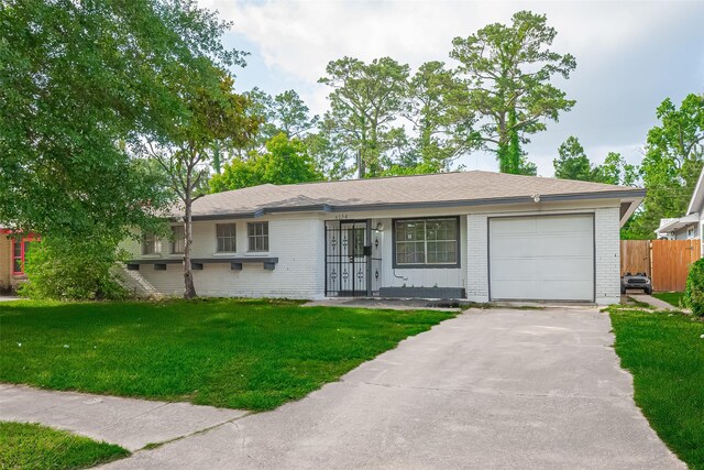 6134 Guadalupe St, Houston, TX 77016 - ranch-style home featuring brick siding, concrete driveway, and an attached garage