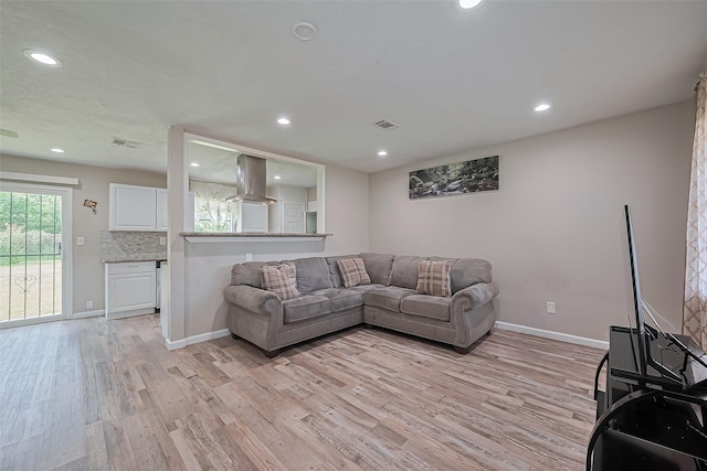 6134 Guadalupe St, Houston, TX 77016 - living area featuring light wood-style floors, recessed lighting, and baseboards