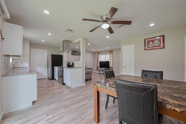 6134 Guadalupe St, Houston, TX 77016 - dining area featuring ceiling fan, light wood-type flooring, and recessed lighting