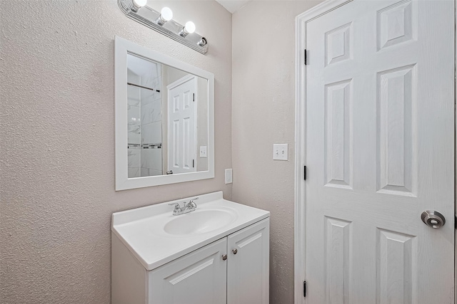 6134 Guadalupe St, Houston, TX 77016 - full bathroom featuring a textured wall, vanity, and a shower