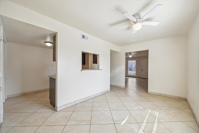 12318-12320 Ormandy St, Houston, TX 77085 - unfurnished room with ceiling fan, light tile patterned floors, and baseboards