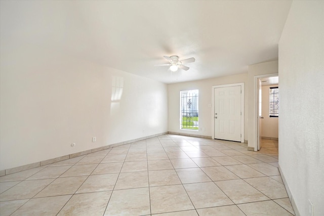 12318-12320 Ormandy St, Houston, TX 77085 - empty room with healthy amount of natural light, ceiling fan, light tile patterned floors, and baseboards
