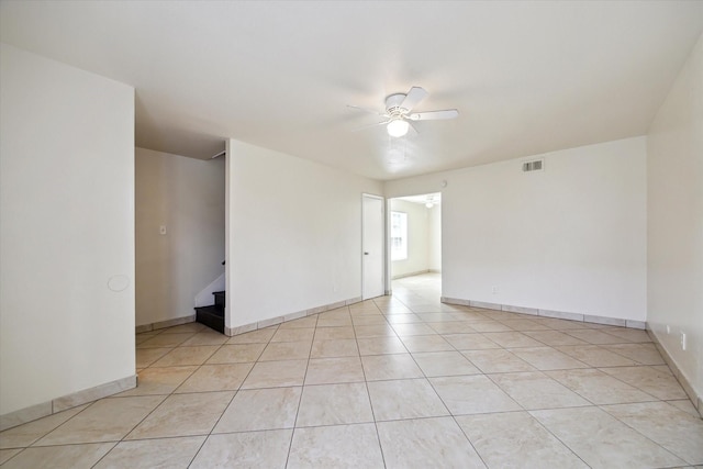 12318-12320 Ormandy St, Houston, TX 77085 - empty room with a ceiling fan, light tile patterned flooring, and baseboards