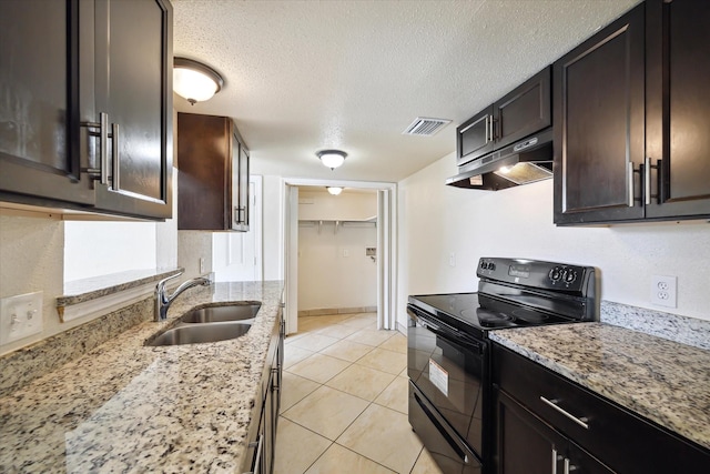 12318-12320 Ormandy St, Houston, TX 77085 - kitchen featuring black range with electric stovetop, under cabinet range hood, a sink, a textured ceiling, and light stone counters
