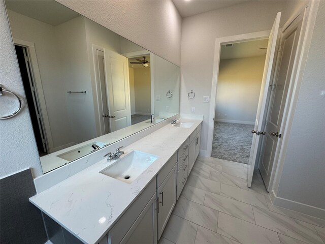 3522 Stonehenge, Montgomery, TX 77356 - bathroom featuring marble finish flooring, baseboards, double vanity, and a ceiling fan