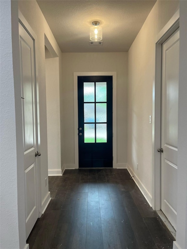 3522 Stonehenge, Montgomery, TX 77356 - doorway with dark wood-style flooring, baseboards, and a textured ceiling