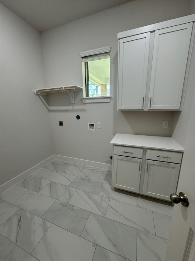 3522 Stonehenge, Montgomery, TX 77356 - washroom featuring hookup for an electric dryer, baseboards, hookup for a washing machine, cabinet space, and light marble finish flooring