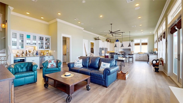 2414 Sand Drift Ln, Crystal Beach, TX 77650 - living area featuring light wood finished floors, recessed lighting, ceiling fan, ornamental molding, and bar area