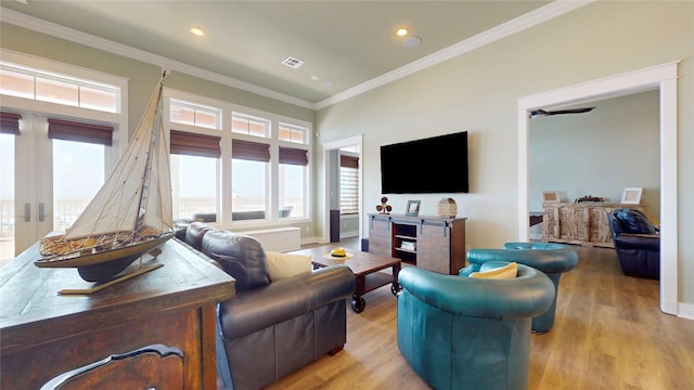 2414 Sand Drift Ln, Crystal Beach, TX 77650 - living room with wood finished floors, ornamental molding, recessed lighting, baseboards, and french doors