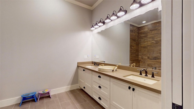 2414 Sand Drift Ln, Crystal Beach, TX 77650 - bathroom featuring crown molding, double vanity, baseboards, and tile patterned floors
