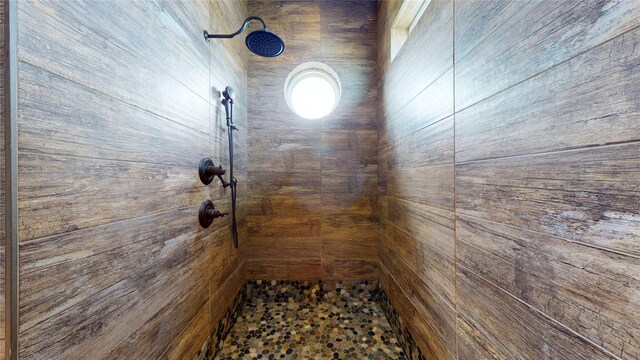 2414 Sand Drift Ln, Crystal Beach, TX 77650 - bathroom view of a tile shower and wooden walls