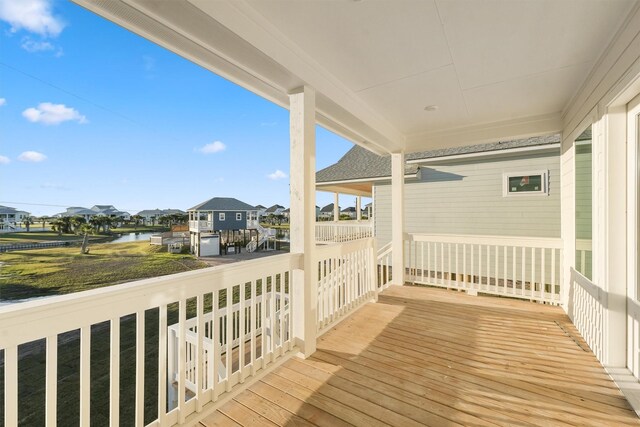 4046 Miramar Ct, Galveston, TX 77554 - wooden terrace featuring a residential view and a water view