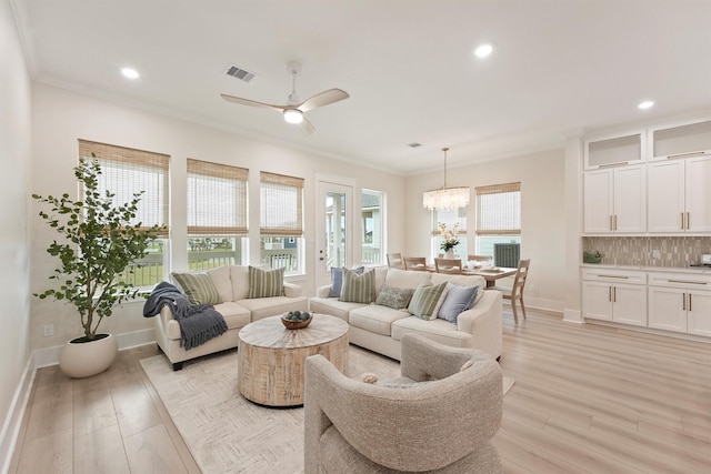 4046 Miramar Ct, Galveston, TX 77554 - living room with a chandelier, crown molding, light wood finished floors, recessed lighting, and baseboards