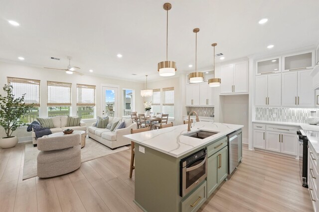 4046 Miramar Ct, Galveston, TX 77554 - kitchen featuring a sink, light wood-type flooring, backsplash, and recessed lighting