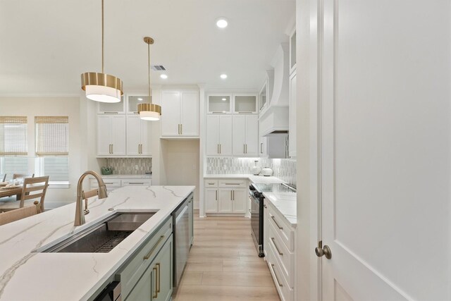 4046 Miramar Ct, Galveston, TX 77554 - kitchen featuring black electric range oven, a sink, light wood-type flooring, dishwasher, and backsplash