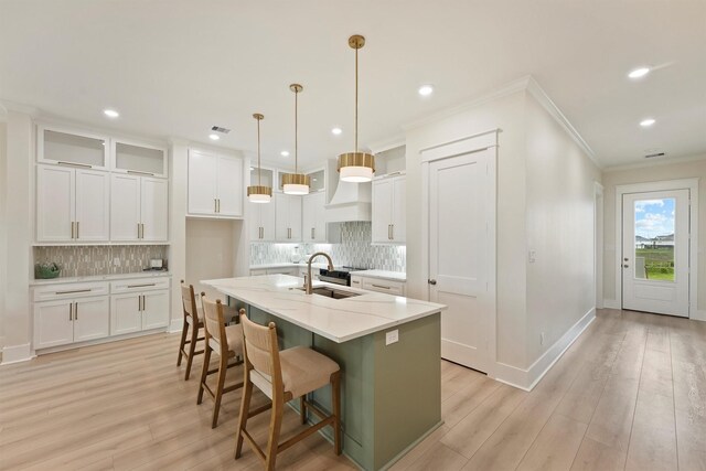 4046 Miramar Ct, Galveston, TX 77554 - kitchen featuring a sink, tasteful backsplash, ornamental molding, white cabinets, and recessed lighting