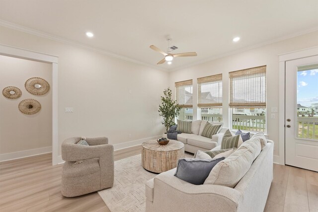 4046 Miramar Ct, Galveston, TX 77554 - living room with crown molding, light wood-style floors, ceiling fan, baseboards, and recessed lighting