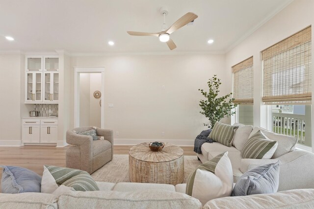 4046 Miramar Ct, Galveston, TX 77554 - living room featuring light wood-style floors, baseboards, a ceiling fan, recessed lighting, and crown molding
